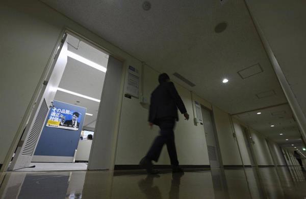 A corridor at the Ministry of Economy, Trade and Industry in Tokyo is dimly lit on Dec. 1, 2022, as an electricity-saving period began in the country for the winter season through March due to power crunch concerns. | KYODO
