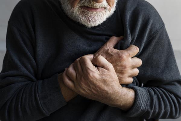 Closeup of elderly man havin<em></em>g heart attack chest pain