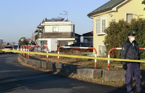 Police watch the crime scene at the home of  Kinuyo Oshio, wher<em></em>e the 90-year-old's body was found, in the city of Komae in western Tokyo on Jan. 20. | KYODO